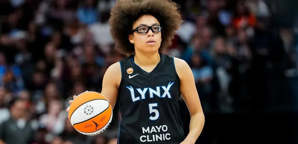 Player holding basketball during game for Lynx