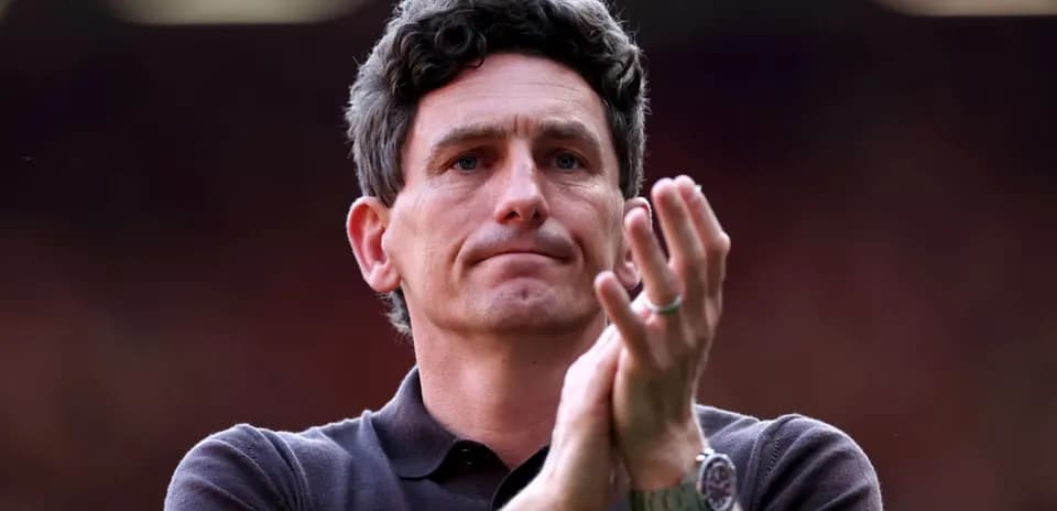 Coach clapping during match at the stadium