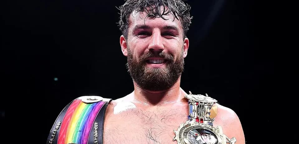 Boxer holding championship belts after victory