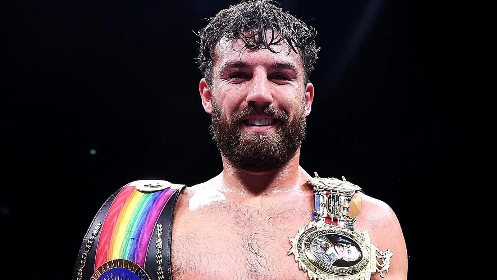 Boxer holding championship belts after victory