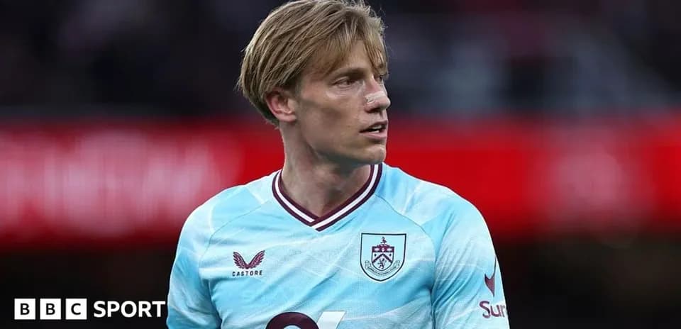 Player in light blue Burnley jersey on field