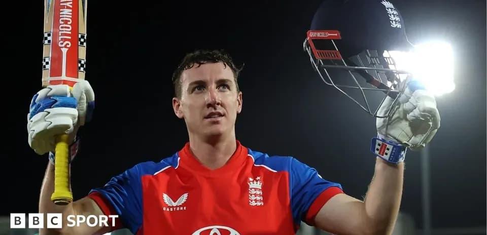 Cricketer celebrating with bat and helmet raised
