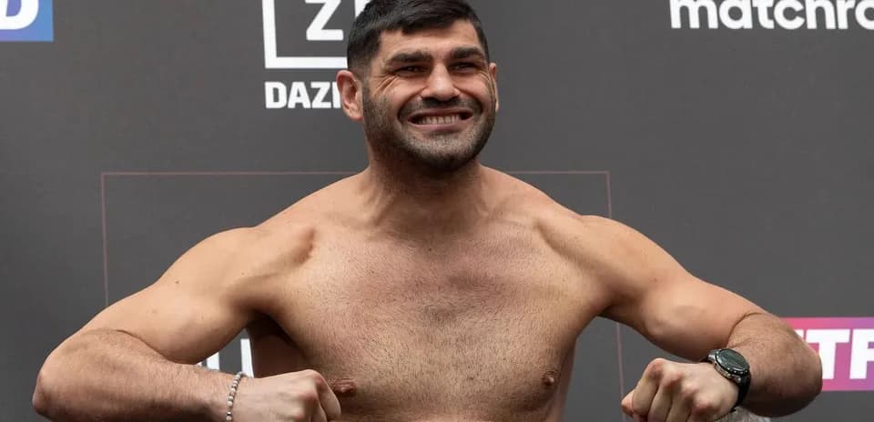 Fighter posing at weigh-in event with a smile