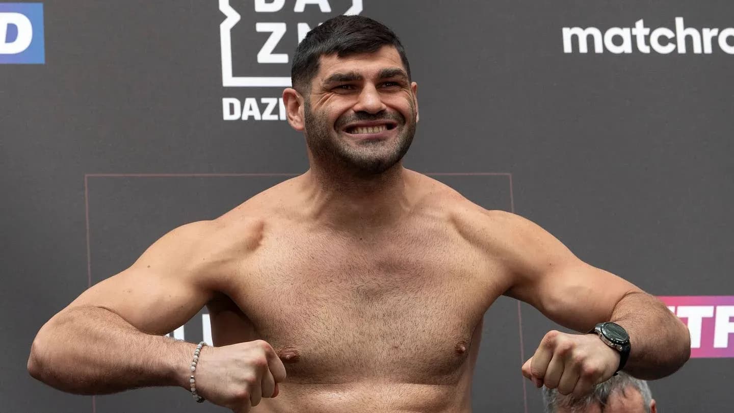 Fighter posing at weigh-in event with a smile