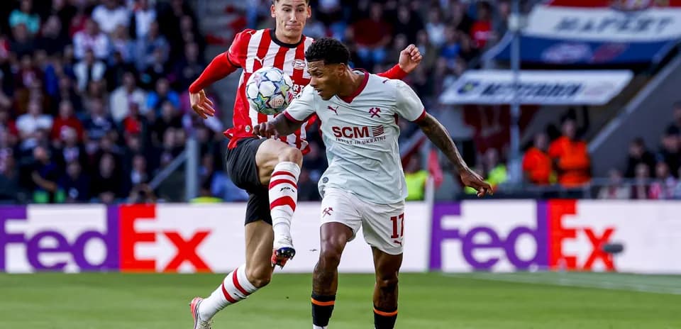 Two players contesting for the ball on the field
