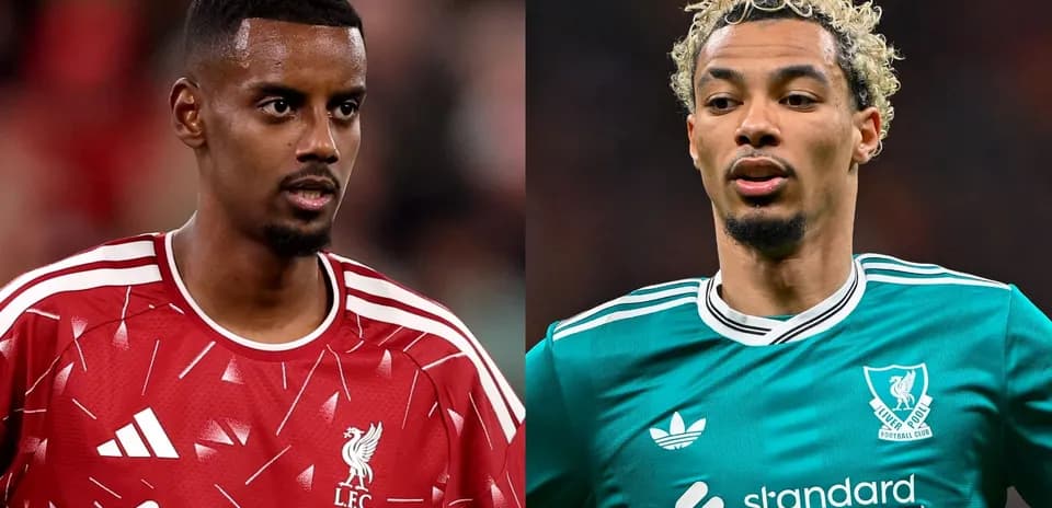 Two Liverpool players in team kits during match