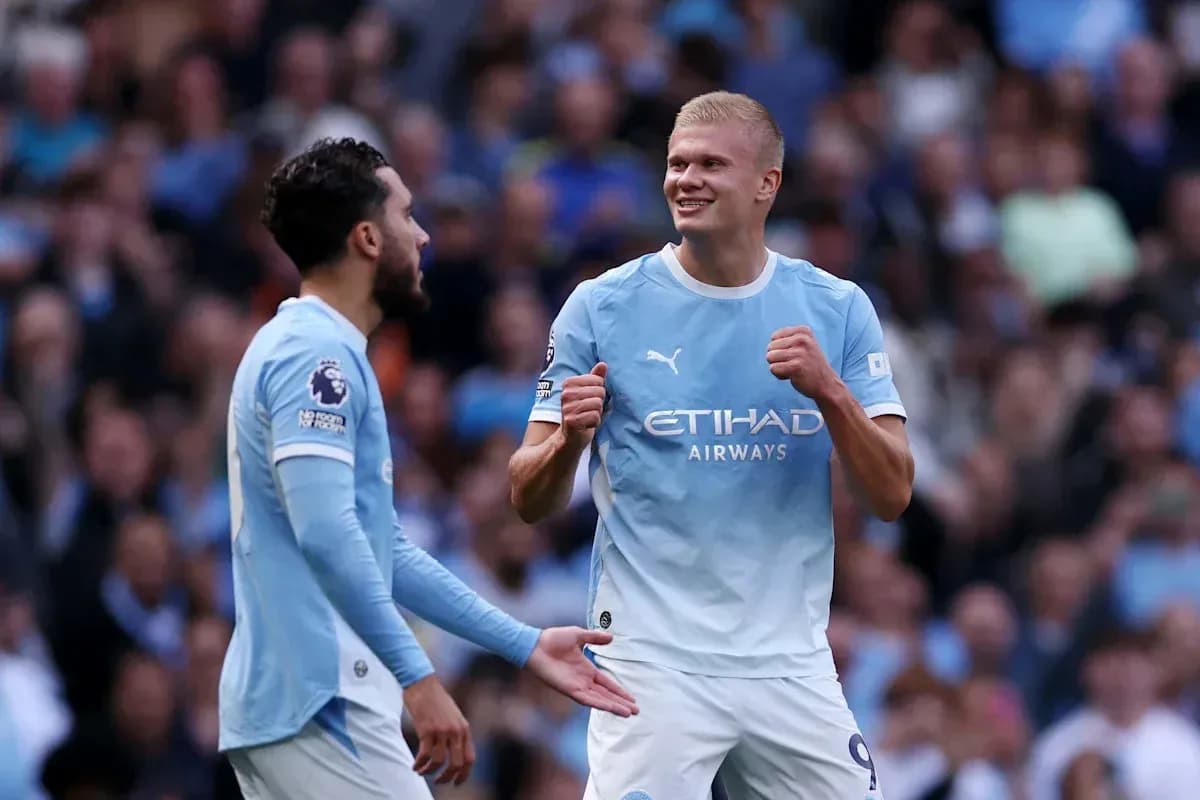 Two Manchester City players celebrating on the field