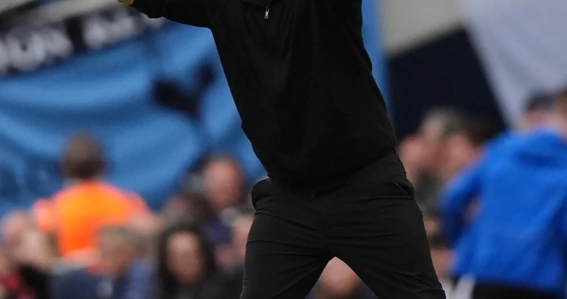 Coach gesturing during a match from the sidelines