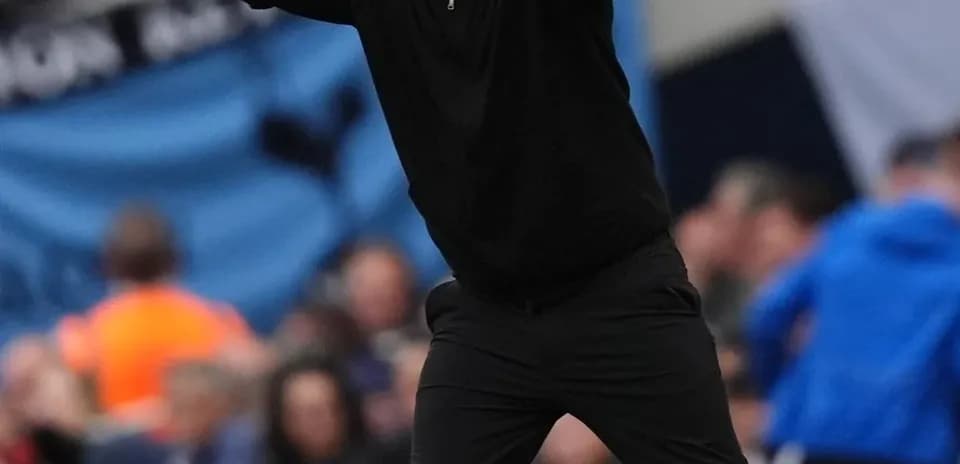 Coach gesturing during a match from the sidelines