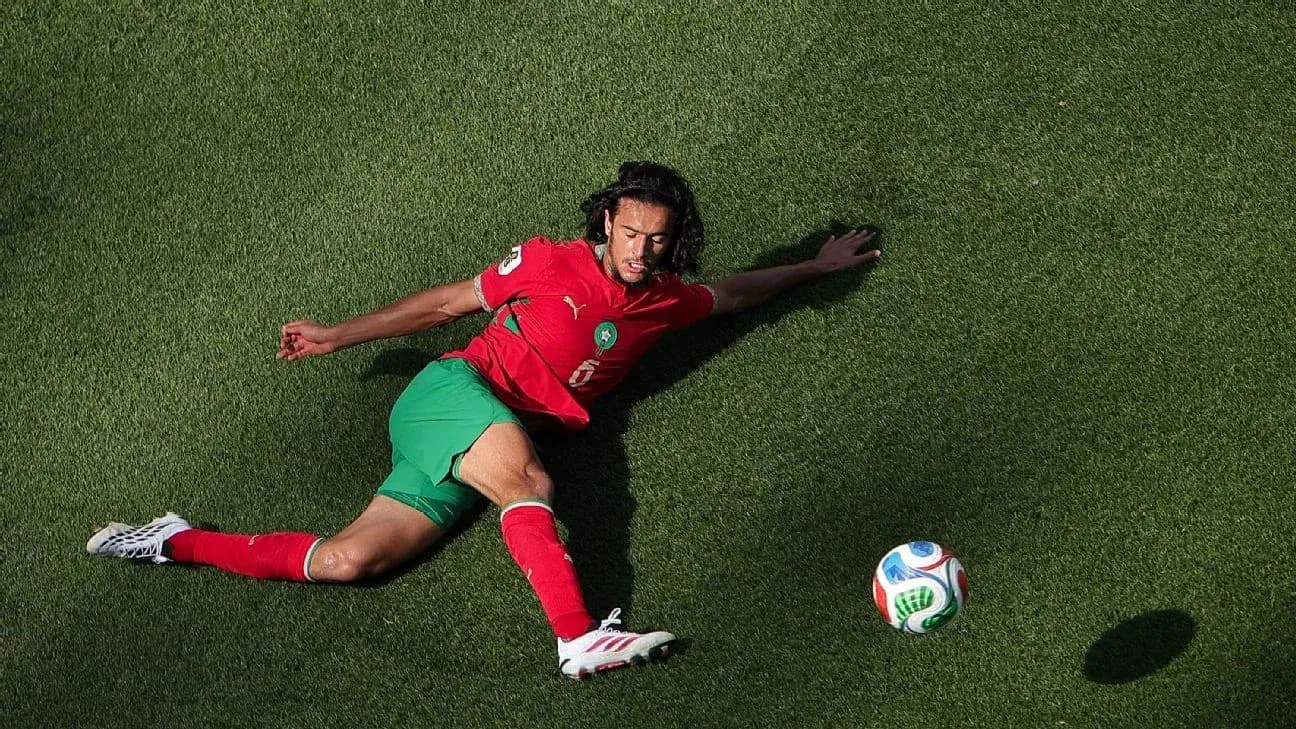Moroccan player sliding on grass towards the ball