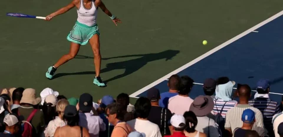 Tennis player hitting a forehand shot during match