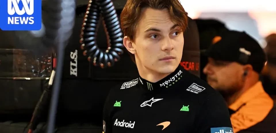 Driver in McLaren team gear in pit area