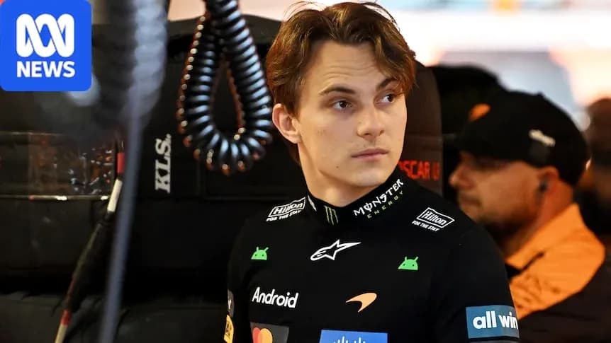 Driver in McLaren team gear in pit area