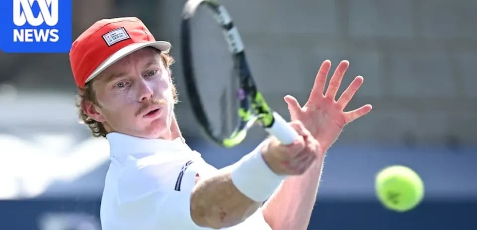 Tennis player hitting a backhand shot on court
