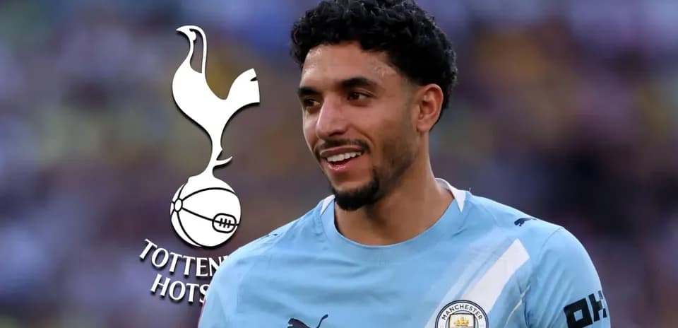 Player smiling in Manchester City kit with logo