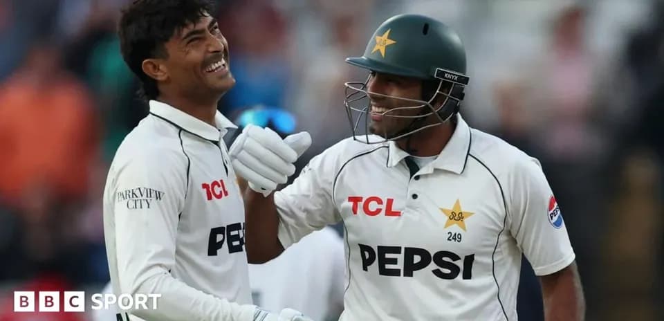 Two cricketers celebrating on the field