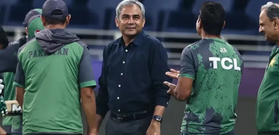 Cricket team staff discussing strategies on field