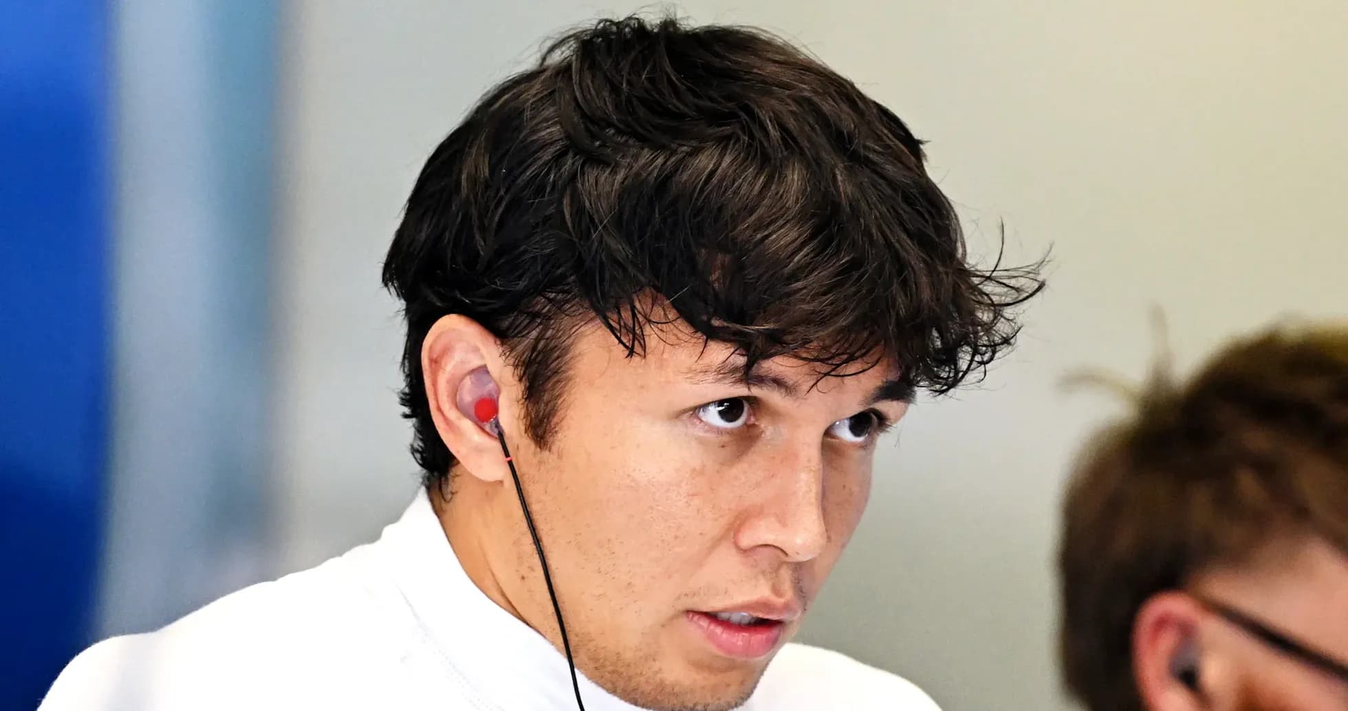 Driver wearing earbuds, focused on the task ahead