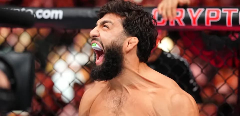 Fighter celebrating with mouthguard during match
