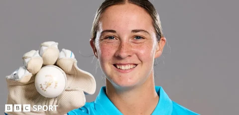 Player holding a cricket ball in glove