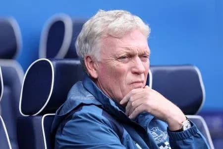 Manager seated, contemplating during match