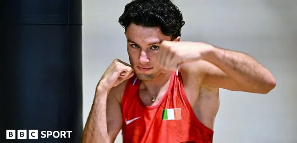 Boxer posing with fist near punching bag