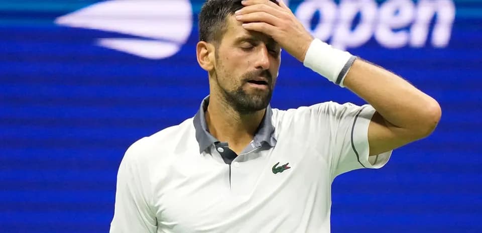 Tennis player with hand on forehead during match