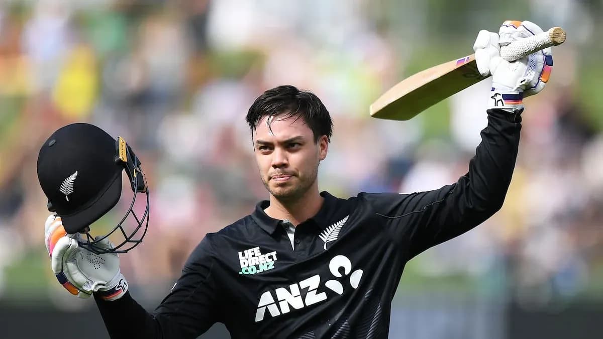 Cricketer celebrating a century with helmet and bat