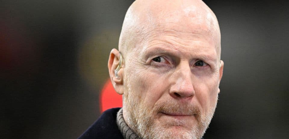 Man with bald head and beard wearing earpiece