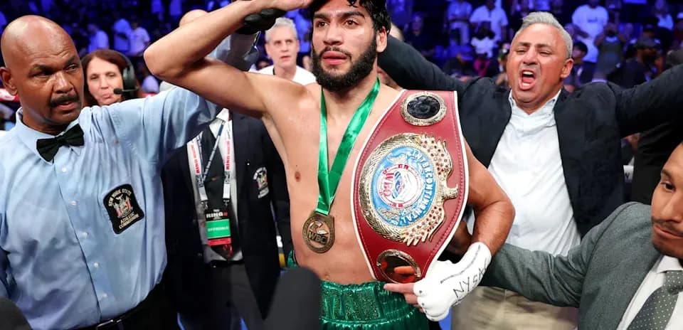Boxer celebrating with championship belt after victory