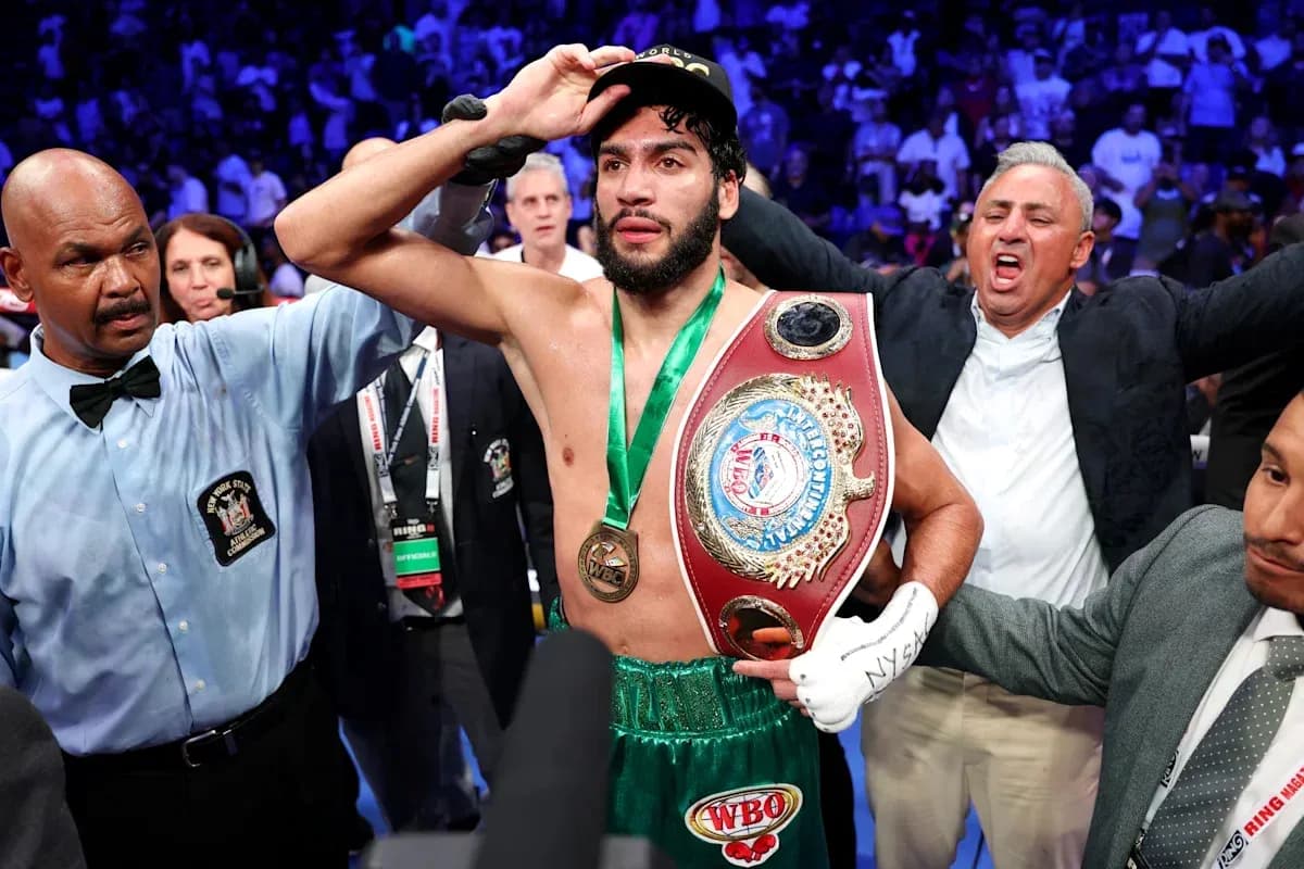 Boxer celebrating with championship belt after victory