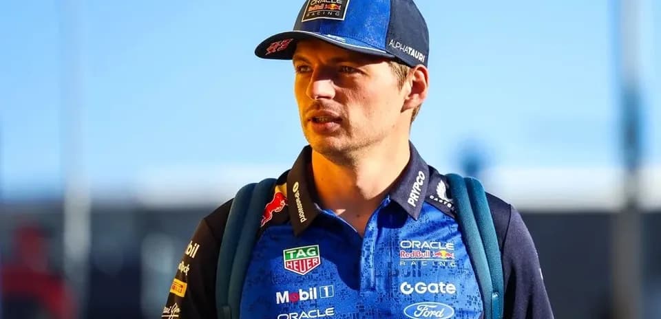 Driver wearing team uniform and cap walking outdoors