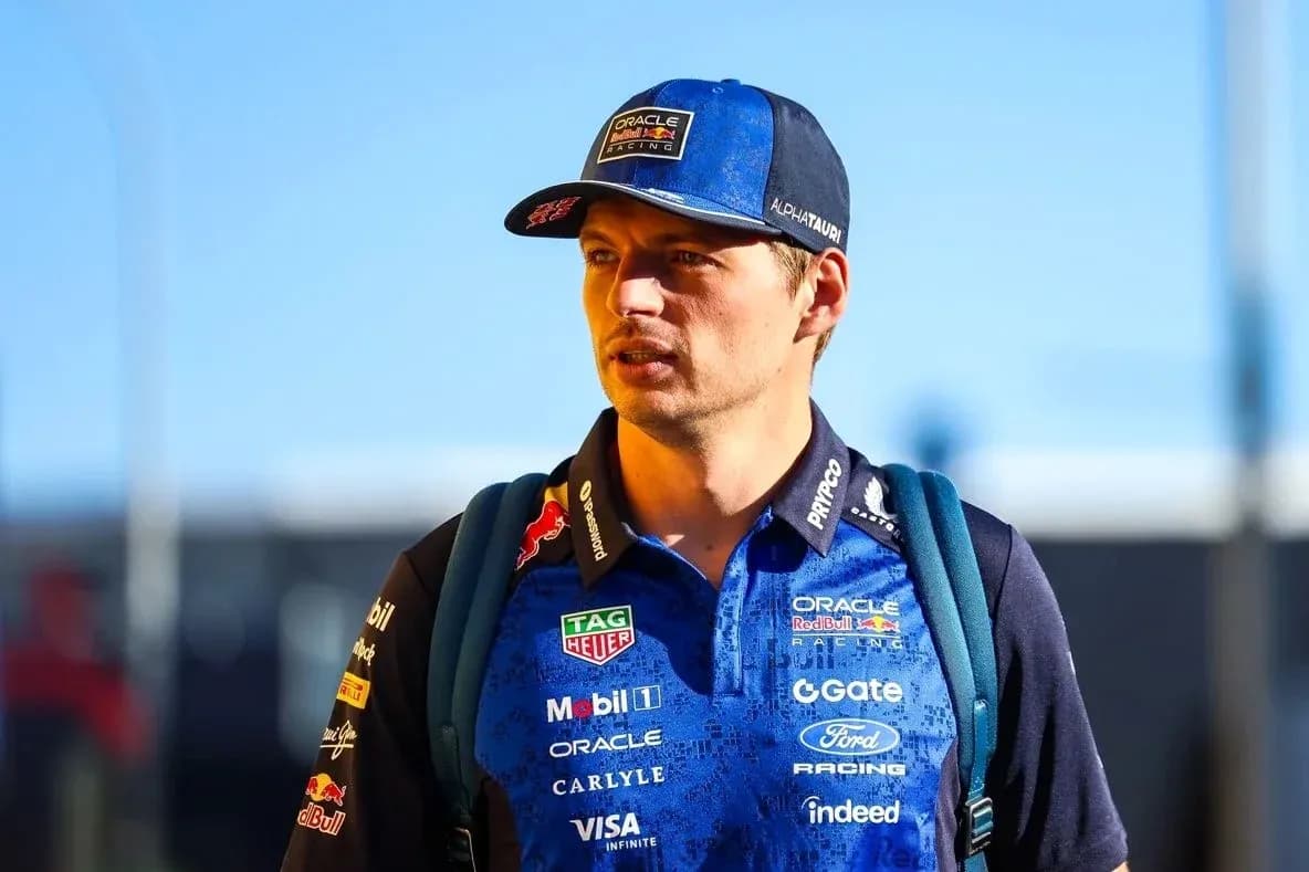 Driver wearing team uniform and cap walking outdoors