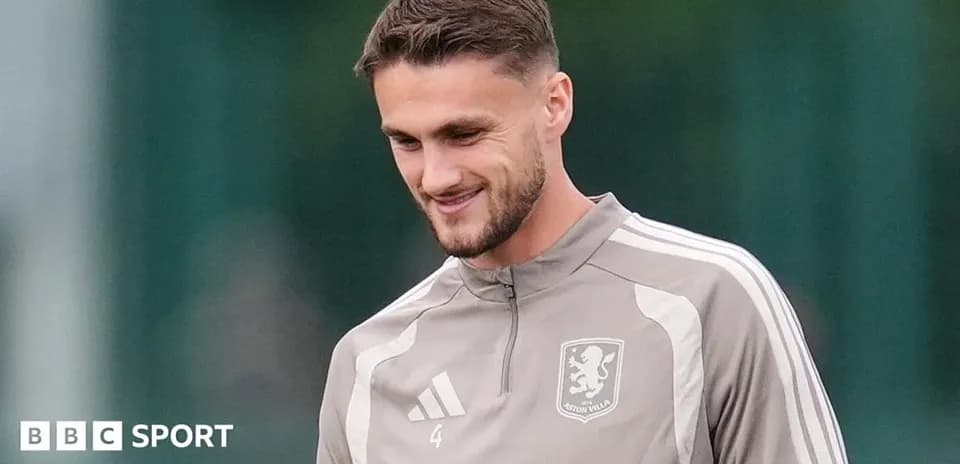 Player in Aston Villa training gear smiling outdoors