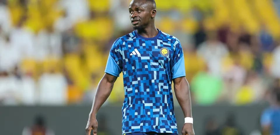 Player in blue patterned jersey on the field