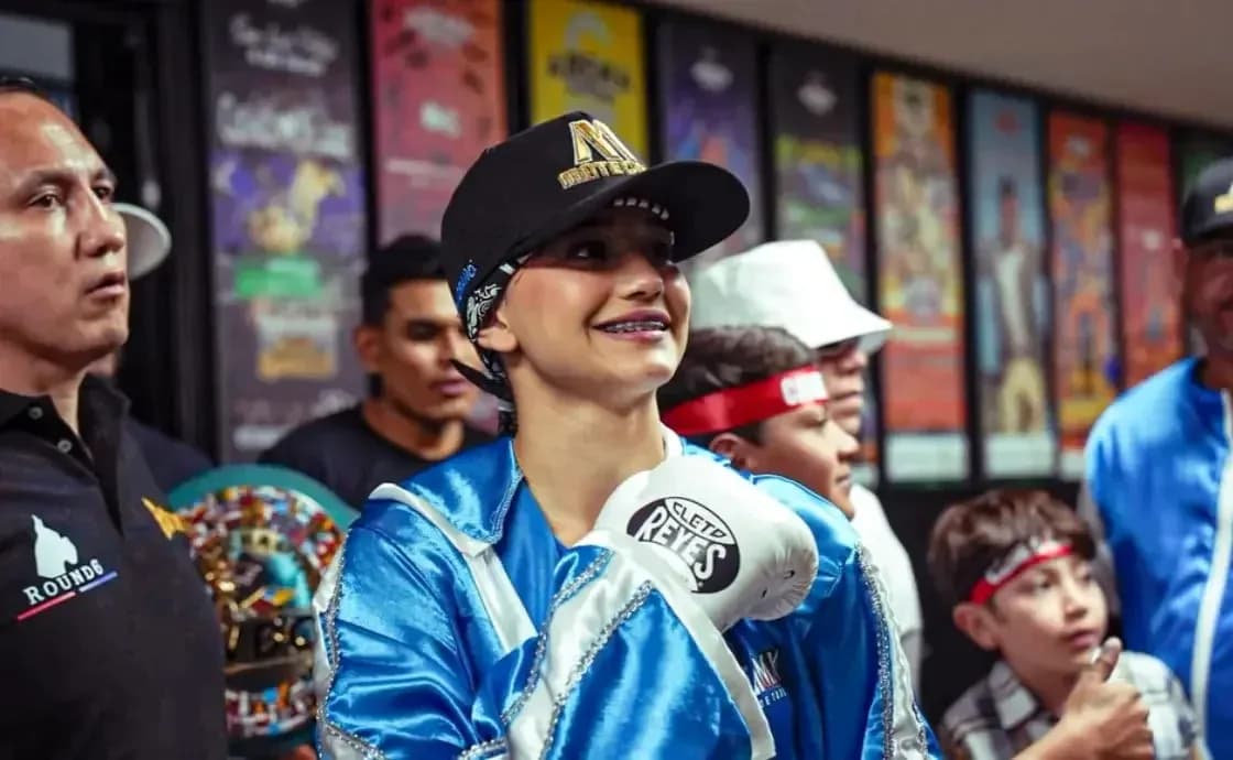 Young female boxer smiling with gloves before match