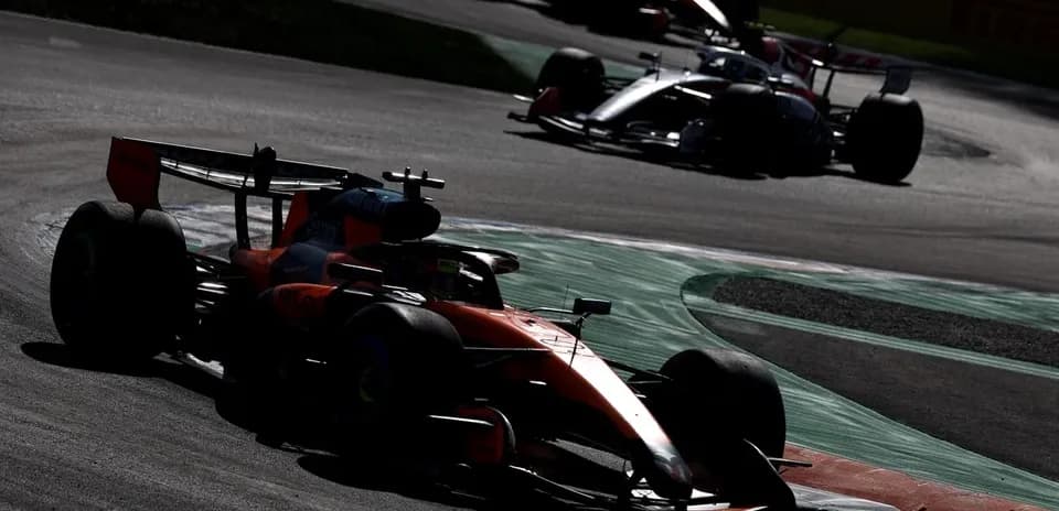 Formula 1 cars racing on track during a race
