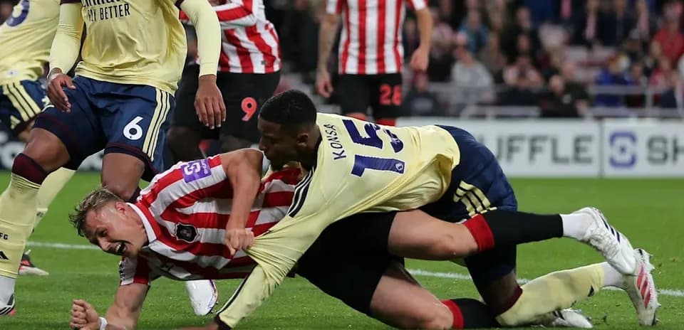 Players battling for possession on the field