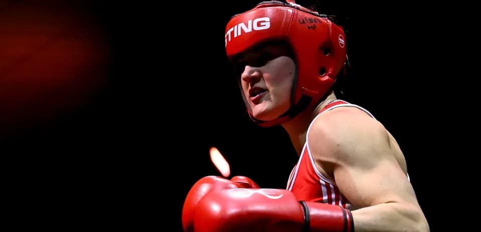 Boxer in red gear preparing for a match