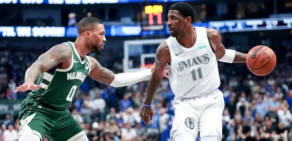 Player dribbling basketball while being defended