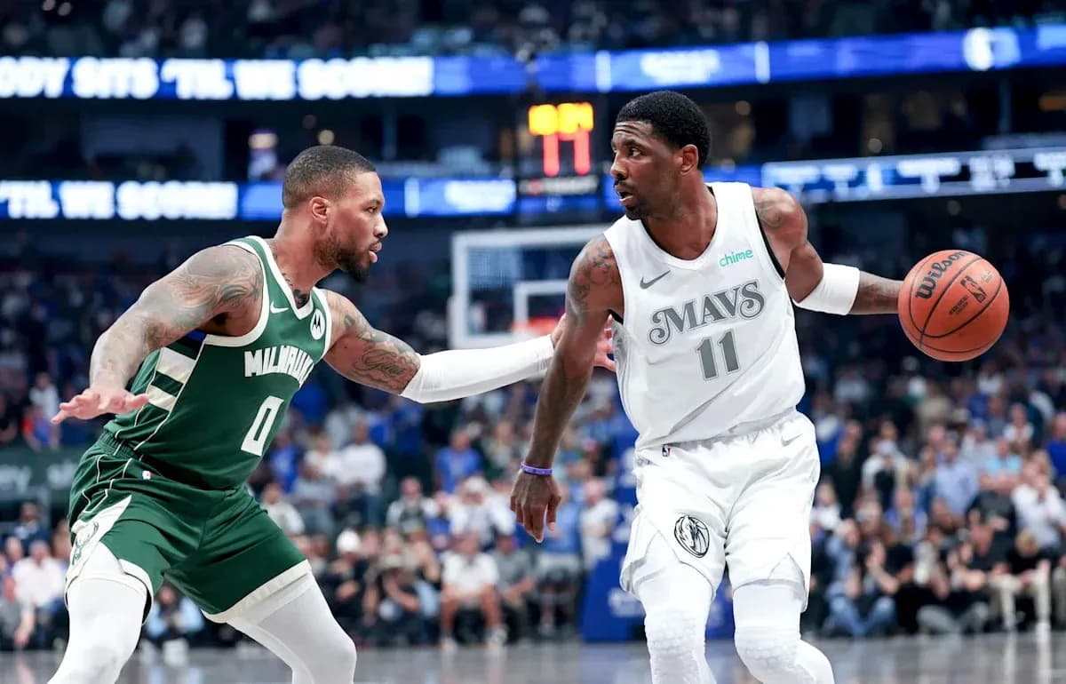Player dribbling basketball while being defended