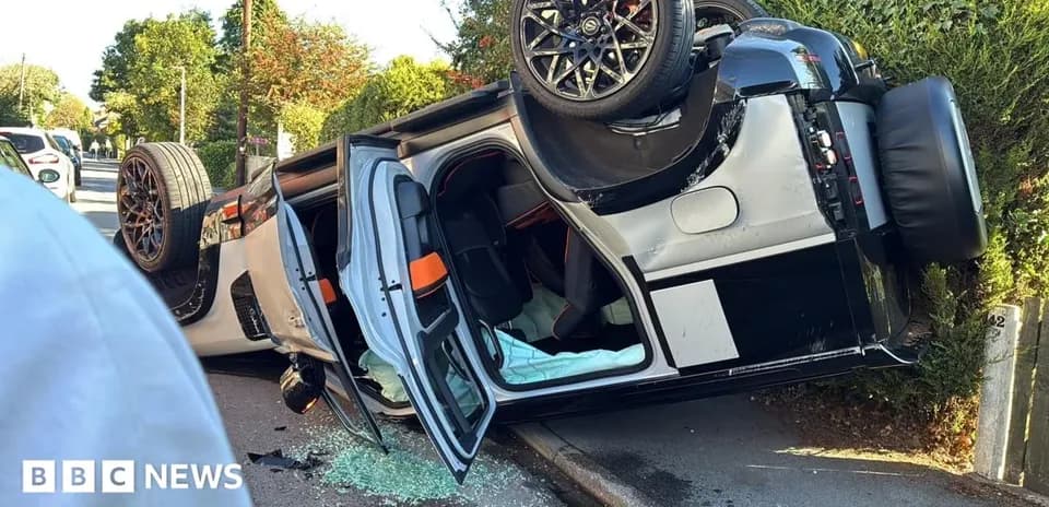 Upside-down car on street with broken glass