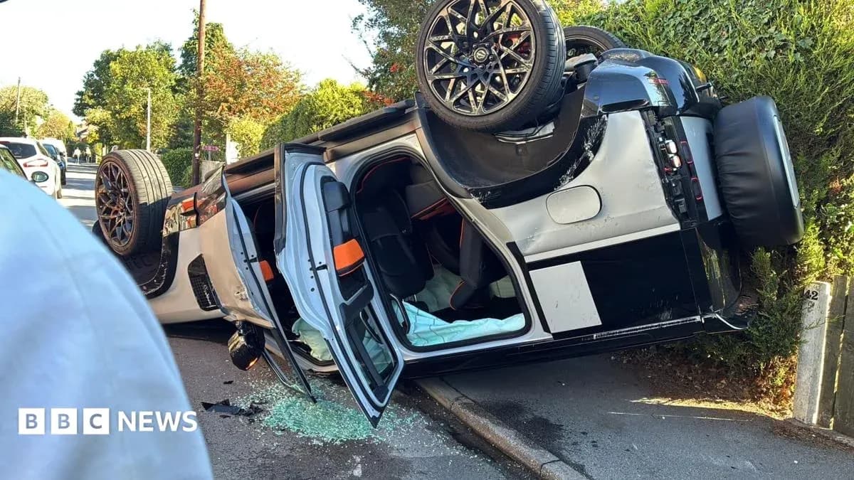 Upside-down car on street with broken glass