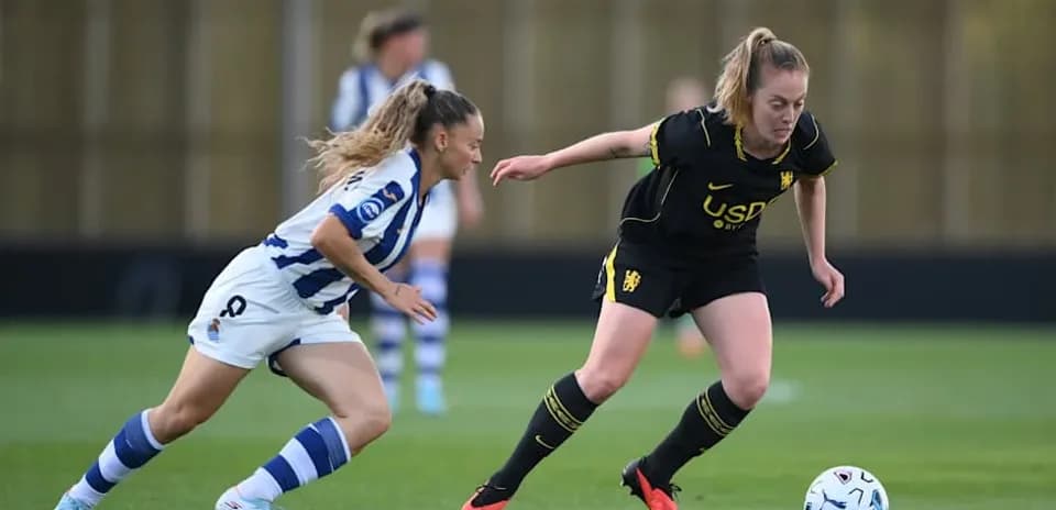 Two players competing for the ball on the field