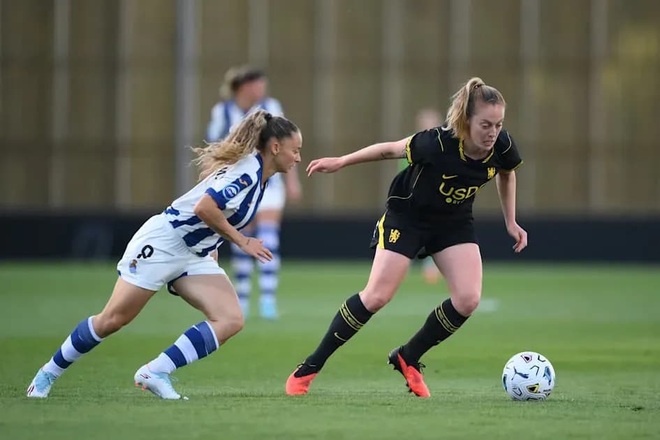 Two players competing for the ball on the field