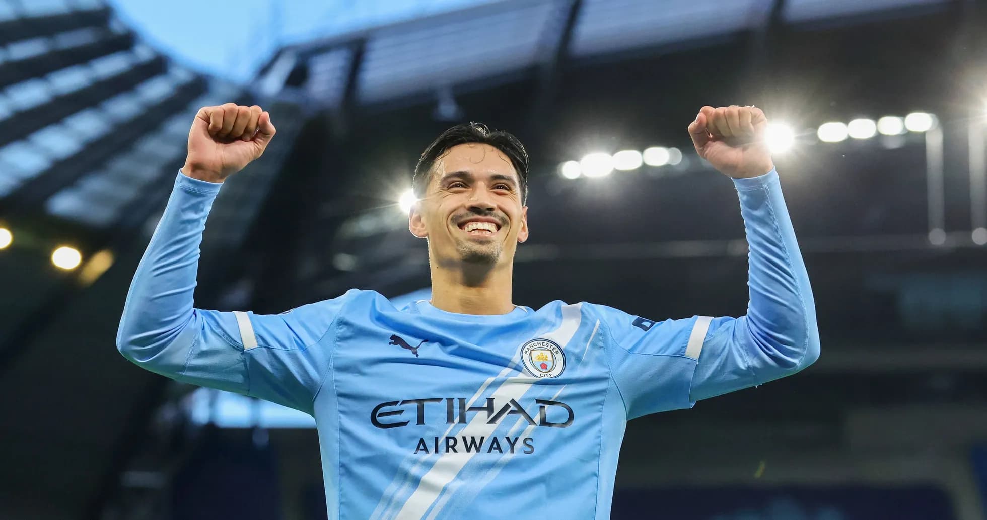 Player celebrating with arms raised at stadium