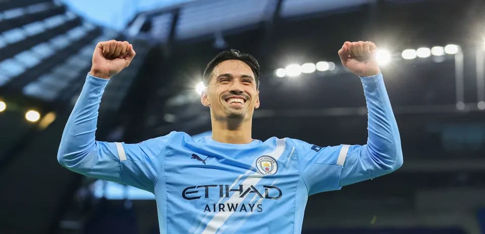 Player celebrating with arms raised at stadium