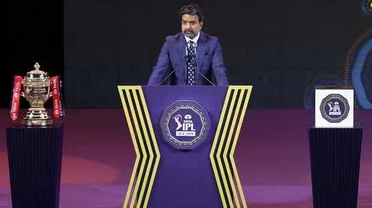 Speaker at IPL event with trophy on podium