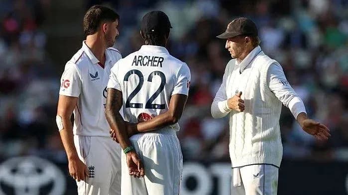 Players discussing strategy during a cricket match