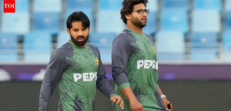 Two Pakistani cricketers walking during practice session